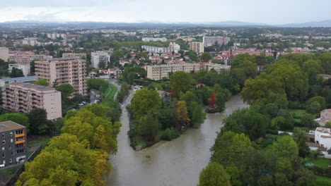 Montpellier-rainy-day-trees-along-le-Lez-river-aerial-view-buildings-les-Aubes